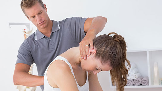 Woman receiving chiropractic adjustment from a Cleveland chiropractor