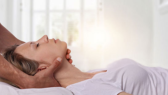 Woman receiving neck adjustment from Cleveland chiropractor